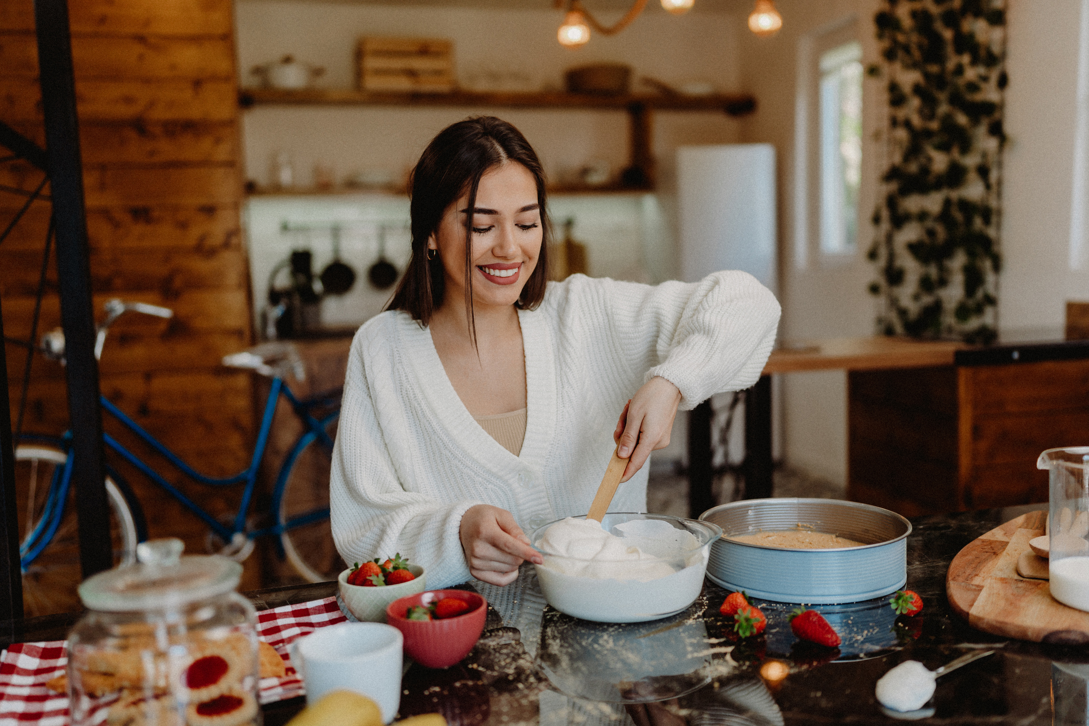 Young woman preparing cheesecake at home