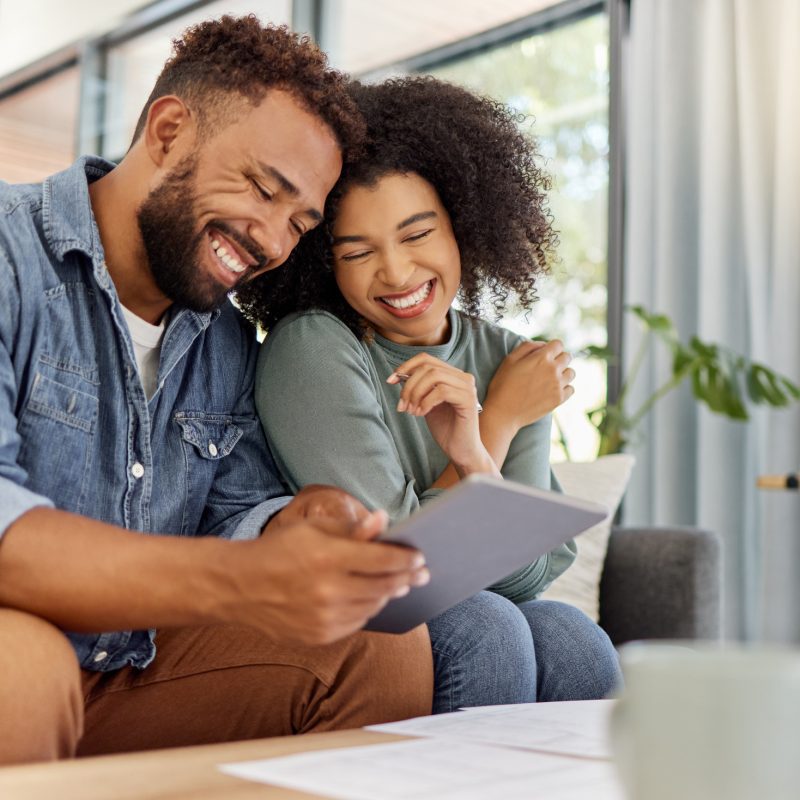 Image: Cheerful couple planning their finances.