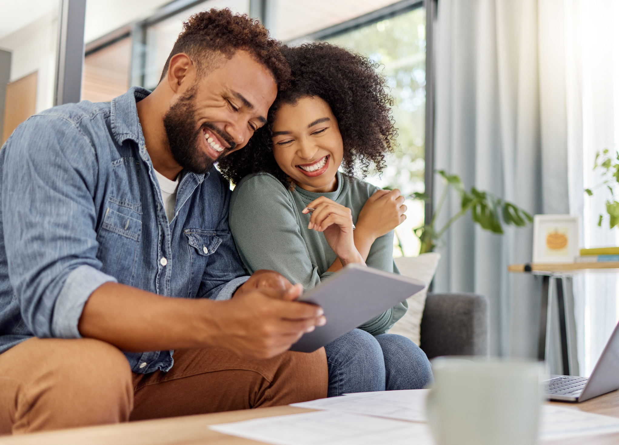 Image: Cheerful couple planning their finances.