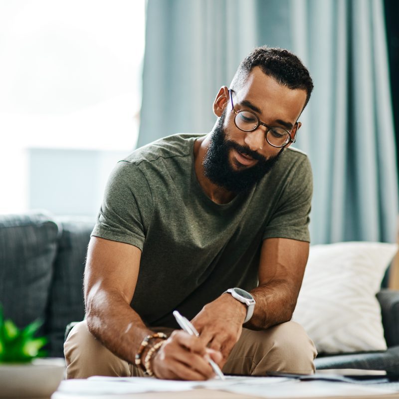 Image: Man going over investment options in his home.