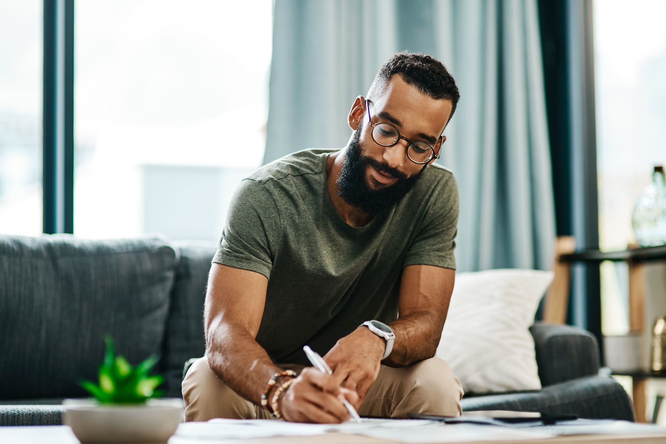 Image: Man going over investment options in his home.